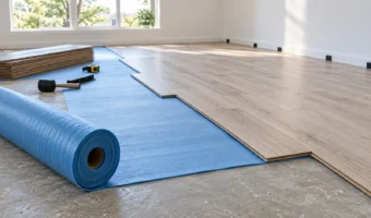 Blue underlayment beneath partially installed laminate flooring